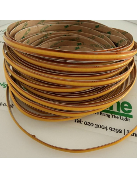 Side view of a dotless 8mm COB LED strip, 3000K warm white, 10m reel