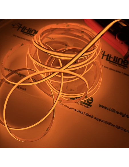 24V amber COB LED tape lit on the reel